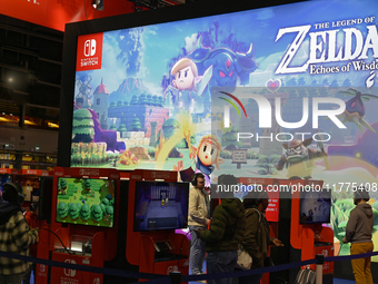 Visitors and gamers play the game ''The Legend of ZELDA'' at the Nintendo stand at the ''Paris Games Week'' video-game fair in Paris, France...