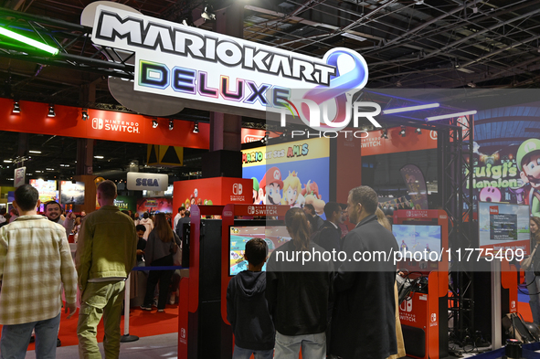 Visitors and gamers play the game ''MARIOKART'' at the Nintendo stand during the ''Paris Games Week'' video-game fair in Paris, France, on O...