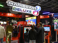 Visitors and gamers play the game ''MARIOKART'' at the Nintendo stand during the ''Paris Games Week'' video-game fair in Paris, France, on O...