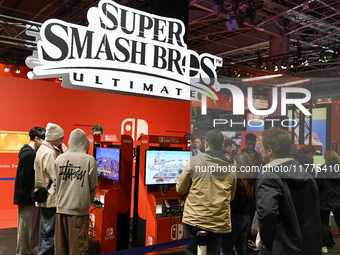 Visitors and gamers play the game ''Super Smash Bros'' at the Nintendo stand at the ''Paris Games Week'' video-game fair in Paris, France, o...