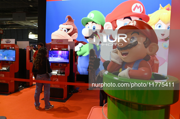 Visitors and gamers play the game ''SUPER MARIO'' at the Nintendo stand during the ''Paris Games Week'' video-game fair in Paris, France, on...