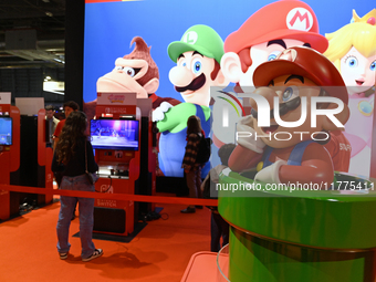 Visitors and gamers play the game ''SUPER MARIO'' at the Nintendo stand during the ''Paris Games Week'' video-game fair in Paris, France, on...