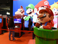 Visitors and gamers play the game ''SUPER MARIO'' at the Nintendo stand during the ''Paris Games Week'' video-game fair in Paris, France, on...