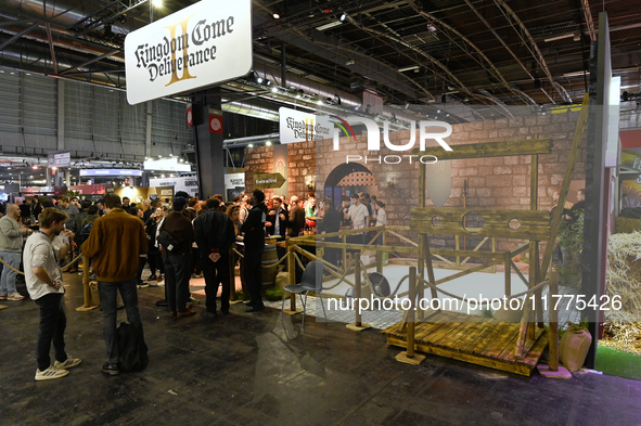 Visitors and gamers stand in front of the ''Kingdom Come: Deliverance'' stand, developed by Warhorse Studios, at the ''Paris Games Week'' vi...