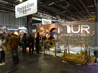 Visitors and gamers stand in front of the ''Kingdom Come: Deliverance'' stand, developed by Warhorse Studios, at the ''Paris Games Week'' vi...