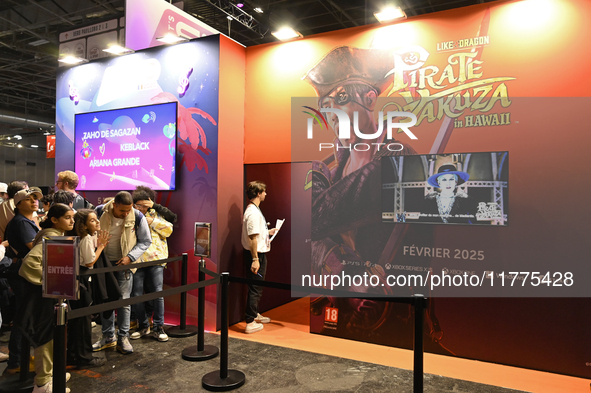 Visitors and gamers wait to play the game ''Pirate Yakuza in Hawaii,'' edited by Sega, at the ''Paris Games Week'' video-game fair in Paris,...