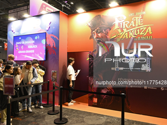 Visitors and gamers wait to play the game ''Pirate Yakuza in Hawaii,'' edited by Sega, at the ''Paris Games Week'' video-game fair in Paris,...