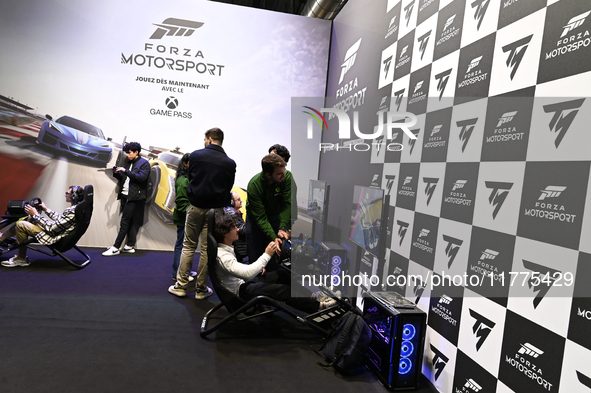 Visitors and gamers play the racing game ''Forza Motorsport,'' edited by Xbox Game Studios, at the ''Paris Games Week'' video-game fair in P...