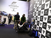 Visitors and gamers play the racing game ''Forza Motorsport,'' edited by Xbox Game Studios, at the ''Paris Games Week'' video-game fair in P...