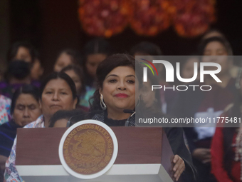 Clara Brugada, head of government of Mexico City, accompanies Claudia Sheinbaum (white jacket), president of Mexico, at the National Palace...