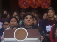 Clara Brugada, head of government of Mexico City, accompanies Claudia Sheinbaum (white jacket), president of Mexico, at the National Palace...