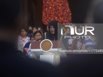 Indigenous women artisans accompany Claudia Sheinbaum (white jacket), President of Mexico, at the National Palace in Mexico City, Mexico, du...