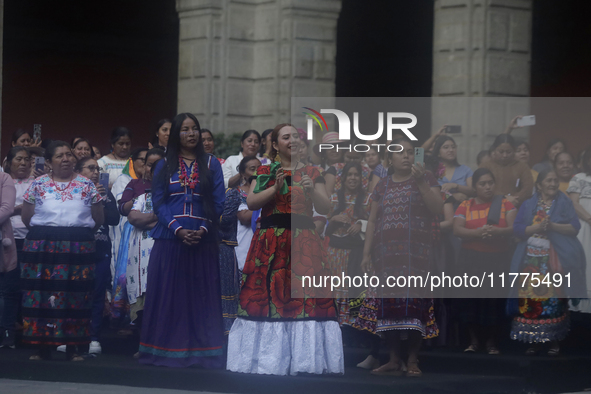 Indigenous women artisans accompany Claudia Sheinbaum (white jacket), President of Mexico, at the National Palace in Mexico City, Mexico, du...