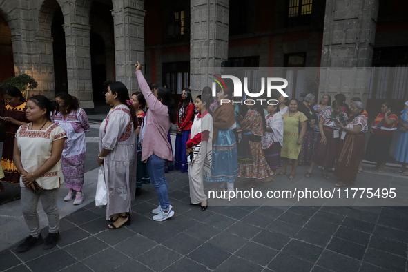 Indigenous women artisans accompany Claudia Sheinbaum (white jacket), President of Mexico, at the National Palace in Mexico City, Mexico, du...