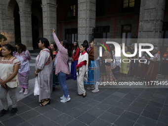 Indigenous women artisans accompany Claudia Sheinbaum (white jacket), President of Mexico, at the National Palace in Mexico City, Mexico, du...