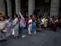 Indigenous women artisans accompany Claudia Sheinbaum (white jacket), President of Mexico, at the National Palace in Mexico City, Mexico, du...