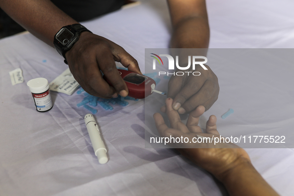 A person takes a free diabetes test on World Diabetes Day at a hospital in Dhaka, Bangladesh, on November 14, 2024. 