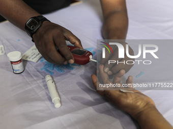 A person takes a free diabetes test on World Diabetes Day at a hospital in Dhaka, Bangladesh, on November 14, 2024. (