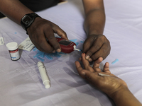 A person takes a free diabetes test on World Diabetes Day at a hospital in Dhaka, Bangladesh, on November 14, 2024. (