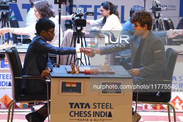 Norway's five-time world chess champion Magnus Carlsen (right) and Indian R Praggnanandhaa participate on the first day of the 6th Tata Stee...