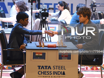 Norway's five-time world chess champion Magnus Carlsen (right) and Indian R Praggnanandhaa participate on the first day of the 6th Tata Stee...