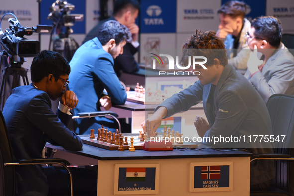 Norway's five-time world chess champion Magnus Carlsen (right) and Indian R Praggnanandhaa participate on the first day of the 6th Tata Stee...