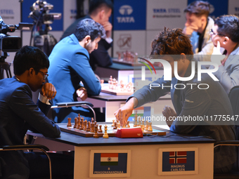 Norway's five-time world chess champion Magnus Carlsen (right) and Indian R Praggnanandhaa participate on the first day of the 6th Tata Stee...