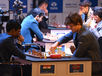 Norway's five-time world chess champion Magnus Carlsen (right) and Indian R Praggnanandhaa participate on the first day of the 6th Tata Stee...