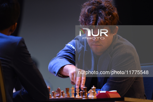 Norway's five-time world chess champion Magnus Carlsen (right) and Indian R Praggnanandhaa participate on the first day of the 6th Tata Stee...