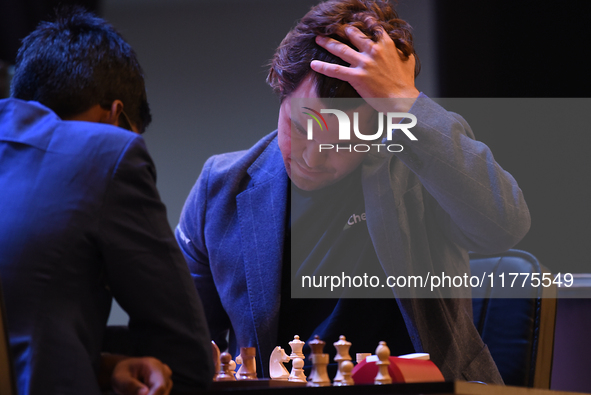 Norway's five-time world chess champion Magnus Carlsen (right) and Indian R Praggnanandhaa participate on the first day of the 6th Tata Stee...