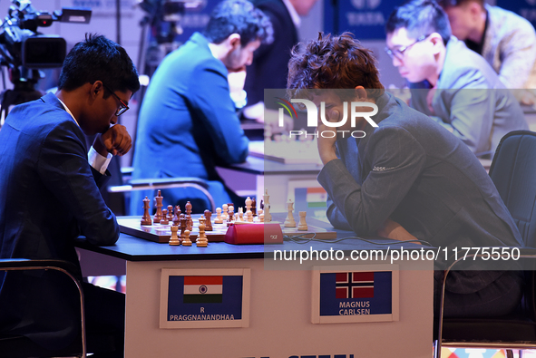 Norway's five-time world chess champion Magnus Carlsen (right) and Indian R Praggnanandhaa participate on the first day of the 6th Tata Stee...