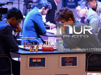 Norway's five-time world chess champion Magnus Carlsen (right) and Indian R Praggnanandhaa participate on the first day of the 6th Tata Stee...