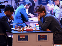 Norway's five-time world chess champion Magnus Carlsen (right) and Indian R Praggnanandhaa participate on the first day of the 6th Tata Stee...