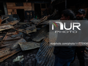 Residents and authorities survey the aftermath of a massive fire that ravages multiple factories in Sopore's Industrial Estate, Jammu and Ka...