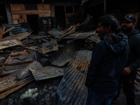 Residents and authorities survey the aftermath of a massive fire that ravages multiple factories in Sopore's Industrial Estate, Jammu and Ka...