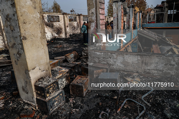 Residents and authorities survey the aftermath of a massive fire that ravages multiple furniture factories in Sopore's Industrial Estate, Ja...