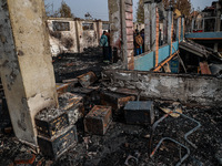 Residents and authorities survey the aftermath of a massive fire that ravages multiple furniture factories in Sopore's Industrial Estate, Ja...