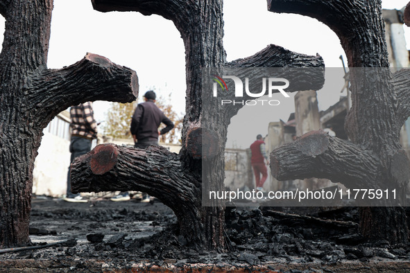 Residents and authorities survey the aftermath of a massive fire that ravages multiple furniture factories in Sopore's Industrial Estate, Ja...