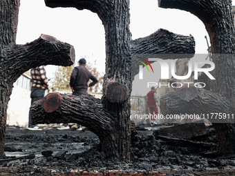 Residents and authorities survey the aftermath of a massive fire that ravages multiple furniture factories in Sopore's Industrial Estate, Ja...