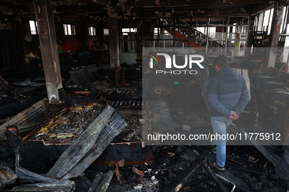 Residents and authorities survey the aftermath of a massive fire that ravages multiple furniture factories in Sopore's Industrial Estate, Ja...