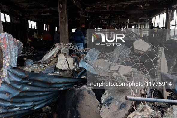 Residents and authorities survey the aftermath of a massive fire that ravages multiple furniture factories in Sopore's Industrial Estate, Ja...