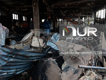 Residents and authorities survey the aftermath of a massive fire that ravages multiple furniture factories in Sopore's Industrial Estate, Ja...