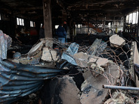 Residents and authorities survey the aftermath of a massive fire that ravages multiple furniture factories in Sopore's Industrial Estate, Ja...