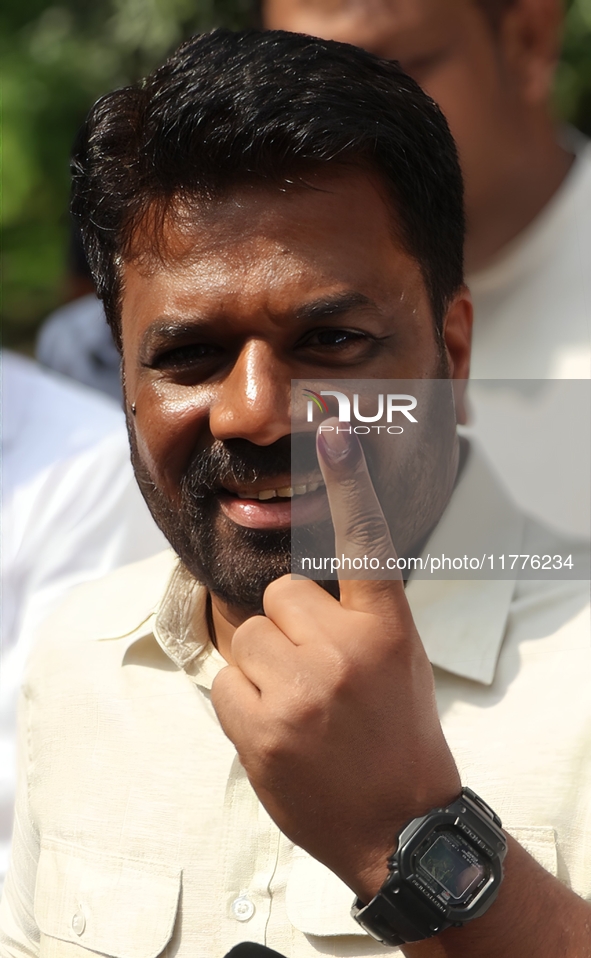 Sri Lankan President Anura Kumara Dissanayake shows his finger marked with indelible ink after casting his vote for the parliamentary electi...