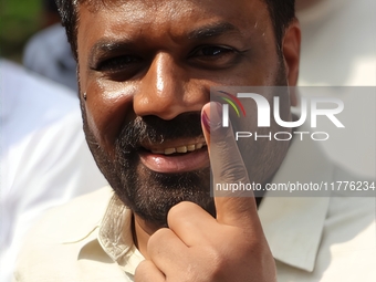 Sri Lankan President Anura Kumara Dissanayake shows his finger marked with indelible ink after casting his vote for the parliamentary electi...