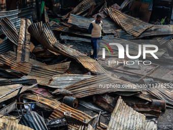 A man surveys the aftermath of a massive fire that ravages multiple factories in Sopore's Industrial Estate, Jammu and Kashmir, India, on No...