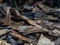 A man surveys the aftermath of a massive fire that ravages multiple factories in Sopore's Industrial Estate, Jammu and Kashmir, India, on No...