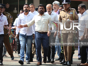 Sri Lankan president Anura Kumara Dissanayake acknowledges his supporters after casting his vote for the parliamentary election in Colombo,...