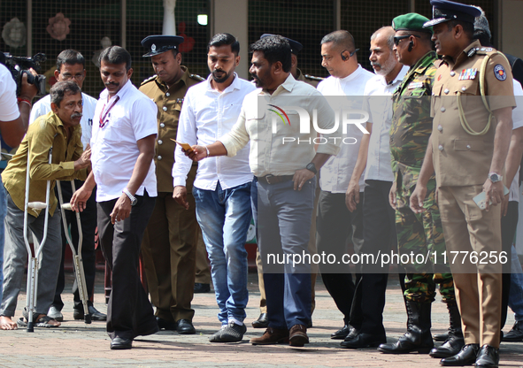 Sri Lankan president Anura Kumara Dissanayake acknowledges a differently-abled supporter after casting his vote for the parliamentary electi...