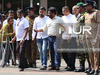 Sri Lankan president Anura Kumara Dissanayake acknowledges a differently-abled supporter after casting his vote for the parliamentary electi...